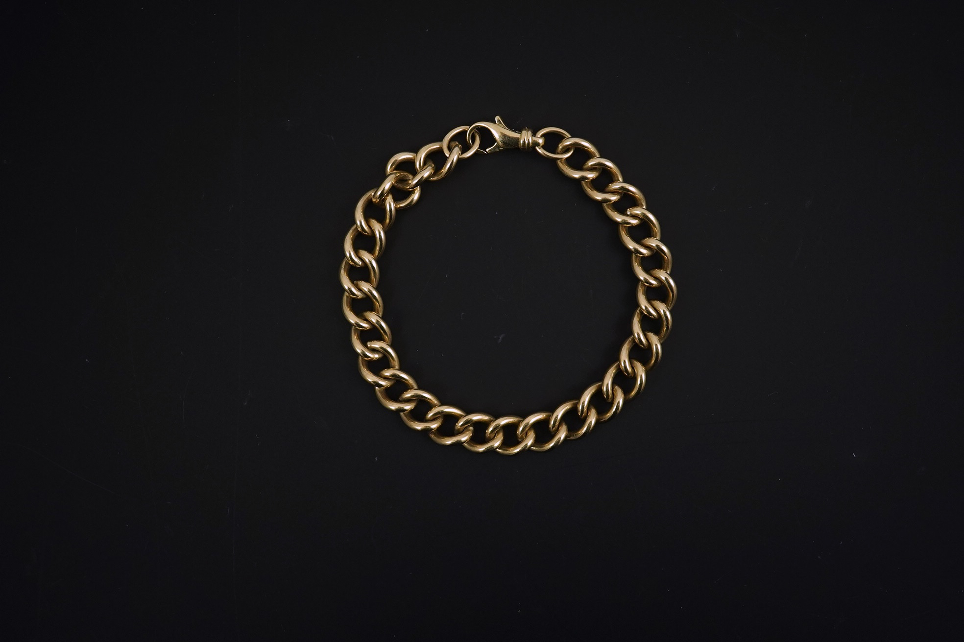 A modern 9ct gold shaped oval link bracelet